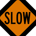 Slow (stop/slow paddle) road sign (MUTCD CW20-8)