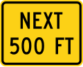 Next (distance) feet road sign (MUTCD W16-4P)