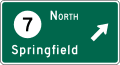 Destination with route shield (Circular Intersection) (1-line) road sign (MUTCD D1-1e)