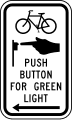 Bicycle push button for green light with arrow road sign (MUTCD R10-26)
