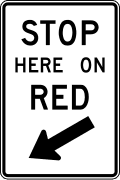 Stop here on red road sign (MUTCD R10-6)