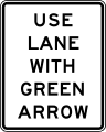 Use lane with green arrow road sign (MUTCD R10-8)