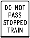 Do not pass stopped train road sign (MUTCD R15-5a)