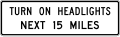 Turn on headlights next (distance) miles road sign (MUTCD R16-7)