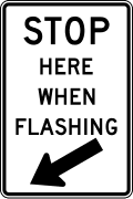 Stop here when flashing road sign (MUTCD R8-10)