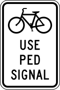 Bicycles use pedestrian signal road sign (MUTCD R9-5)